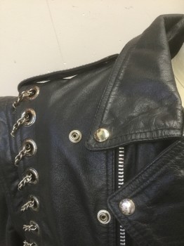 JAMIN LEATHER, Black, Leather, Solid, Motorcycle Jacket, Zip Front, Silver Metal Chain Woven Through Large Silver Grommets at Armscyes, Epaulettes at Shoulders, 3 Zip Pockets + 1 Flap Pocket with Silver Studs/Snap, **Separate Self Belt with Silver Buckle, Lining is Burgundy Quilted and Detaches