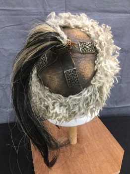 Unisex, Historical Fiction Headpiece, M.T.O, Khaki Brown, Lt Brown, Bronze Metallic, Leather, Synthetic, 24", Mongolian Hat/helmet. Aged Brown Leather Crown with Brass Findings, Dirty Cream/khaki Shearling Trim At Crown and Horsehair Tail At Crown Top. Adjustable Leather Buckled Chin Strap