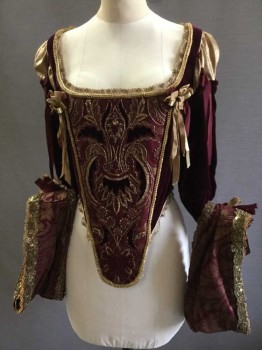 PERIOD CORSETS, Red Burgundy, Gold, Silk, Polyester, Geometric, Floral, Velvet/Velveteen, with Gold/burgundy Brocade Stomacher Festooned with Gold Embroidery and Beading, Burgundy Velvet Appliqué and Embroidery, Trimmed In Ribbon Bows and Ropes, Square Scoop Neck Trimmed with Metallic Gold Lace, Arms-eyes Trimmed with Gold Piping, 3/4 Sleeves, with Brocade Cuffs with Applique, and Beading and Heavily Beaded Trim. Waist Line Also Trimmed with Gold Piping, Lacing/Ties Center Back,