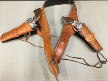 Unisex, Historical Fiction Gunbelt, N/L, Caramel Brown, Brown, Silver, Faux Leather, Metallic/Metal, `, Gun Belt with 2 Gun Holsters, with 2 Prop Guns Inside That Are Not Coded, Belt Is Embossed Western Style Golden Brown Pleather, 2.5" Wide, Prop Guns Are Silver Metal with Brown Handle