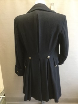 MTO, Black, Wool, Solid, Cut Away Coat in Boiled Wool, Cotton Lining. 4 Faux Buttons & Button Holes at Cut Away.buttons at Cuffs, 2 Pocket Flaps with Buttons. Slit at Center Back, Inverted Pleat Detail at Side Seams at Back. All Buttons Brass Colored. Inverted Pleat at Center Back,
