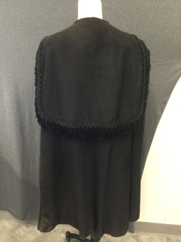 EVA'S, Black, Leather, Rayon, Solid, Black Suede Cape with Black Trim with Fringe at Sailor Collar. 4 Tassles at Front, Hook & Eye Closure, Trim at Center Front, Sun Damage at Shoulder. Repair on Both Shoulders Under Collar. See Photos for Close Up. Some Wear and Dis coloring at Neckline and Hemline