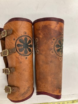 MTO, Lt Brown, Faded Black, Leather, Metallic/Metal, Solid, Floral, Textured, Aged, 4 Brass Buckle Closures. 16" Wide At Top Of Calf. 2 Embossed Medallions, Dark Red Leather Trim At Top And Bottom. PAIR. MULTIPLE