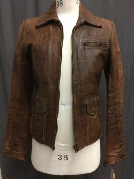 Brown, Leather, Mottled, A Little Aged/Distressed,  Zip Front, 2 Flap Pockets with Diagonal Welt Pocket Details. One Zip Breast Pocket, Side Waist Buckle Straps, Buckle Straps At Cuffs. Tan Plaid Lining