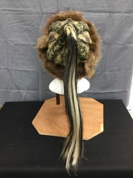 M.T.O., Brown, Gray, Brass Metallic, Black, Cream, Leather, Fur, Mongolian Hat/ Helmet. Worn Brown Leather Hat with Brown Fur Hat Band & Gray Rabbit Fur Panels with Brass Studs and Findings. Black & Cream Horsehair Tail At Top Of Crown. Brown Leather Adjustable Chin Strap with Buckle