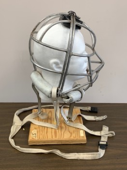 Silver, White, Metallic/Metal, Vinyl, Solid, Metal Cage Helmet, Padding at Neck and the Top of Cage, Missing a Bolt with Butterfly Nut, Leather & Cotton Twill Harness Straps,