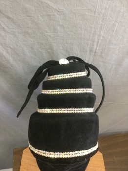 KOKIN, Black, Solid, Black Velvet Step Tiered Hat with Rhinestone Bands, Self Bow Tie on Top with Large Rhinestone, Elastic Strap