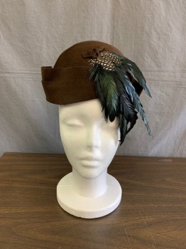 Broadway New York, Brown, Wool, Feathers, Solid, Cloch Style Felt with Double Layer Upturned Brim Detail , Small Matching Felt Knot with Small Blk and Wht Speckled Pheasant ,and a Downward Spray of Iridescent  Green Coque Feathers .